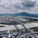 Bright, scenic photograph of the Chattanooga, Tennessee downtown skyline and the Walnut Street Bridge on a clear, sunny da...
